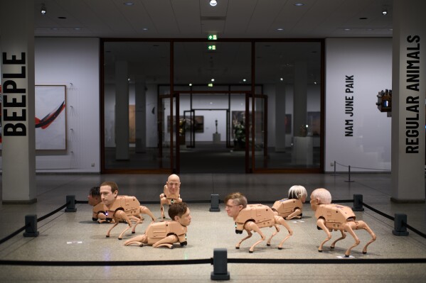 Beeple’s neue nationalgalerie installation: robot dogs with elon musk and mark zuckerberg heads take over berlin art scene